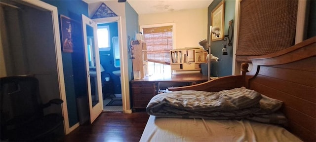 bedroom featuring multiple windows and wood finished floors