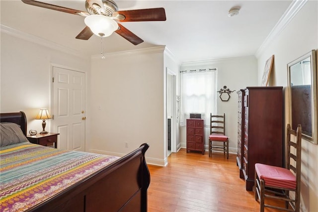 bedroom with ceiling fan, light wood-style floors, baseboards, and ornamental molding