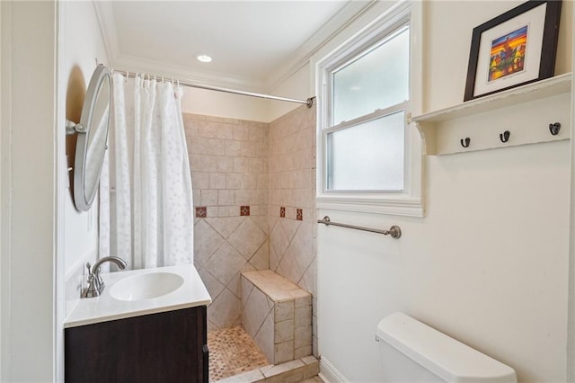 bathroom with toilet, tiled shower, vanity, and ornamental molding