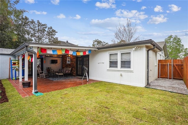 back of house featuring a patio, a lawn, and fence