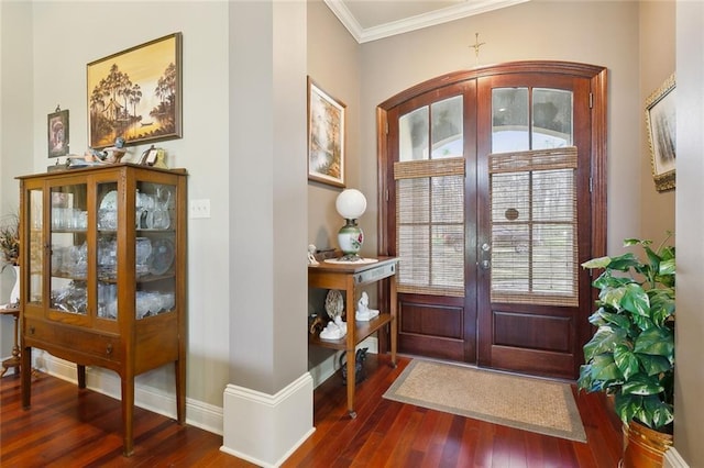 foyer entrance featuring french doors, baseboards, dark wood-type flooring, and ornamental molding