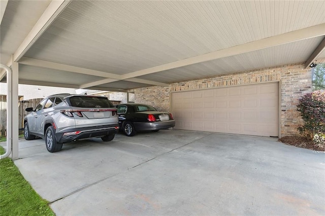 garage with a carport and concrete driveway