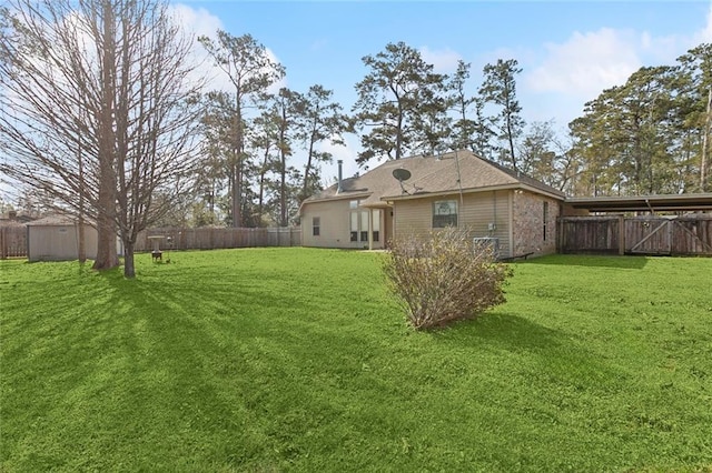 view of yard with an outdoor structure and a fenced backyard