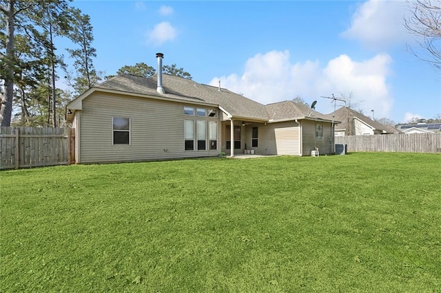 back of property with a yard, a patio, and a fenced backyard