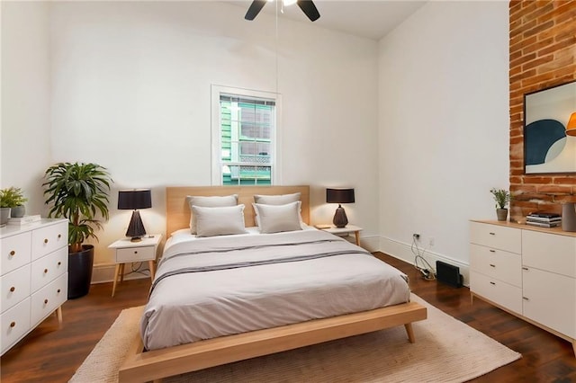 bedroom with baseboards, dark wood-type flooring, and a ceiling fan