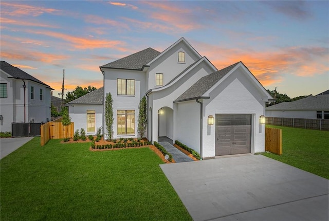 11 Khan Ct, Metairie, LA 70003 - french provincial home featuring a garage, driveway, and roof with shingles