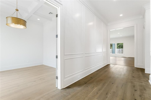 11 Khan Ct, Metairie, LA 70003 - hallway with crown molding, wood finished floors, recessed lighting, beamed ceiling, and a decorative wall