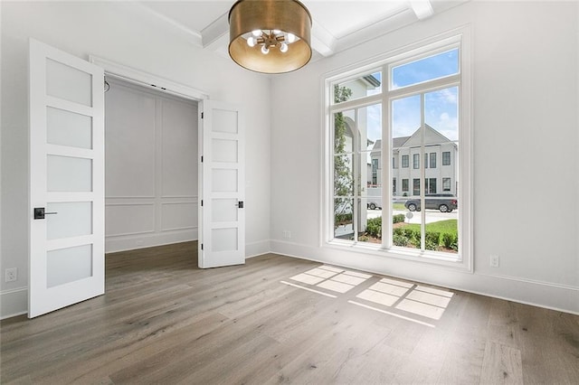 11 Khan Ct, Metairie, LA 70003 - unfurnished dining area with plenty of natural light, wood finished floors, and beam ceiling