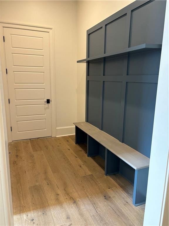 mudroom featuring baseboards and light wood-style flooring