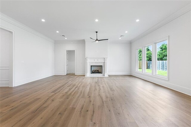 11 Khan Ct, Metairie, LA 70003 - unfurnished living room with a ceiling fan, light wood finished floors, ornamental molding, a high end fireplace, and recessed lighting