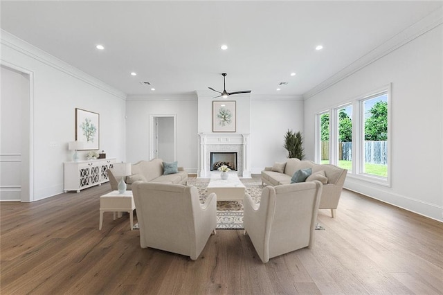 11 Khan Ct, Metairie, LA 70003 - living room with ceiling fan, wood finished floors, a fireplace, recessed lighting, and ornamental molding