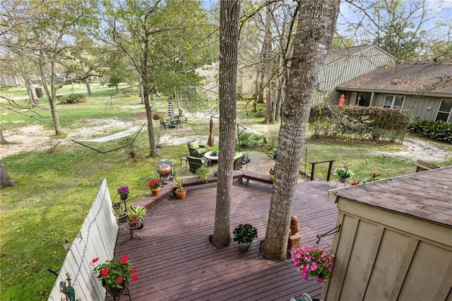 wooden deck with a lawn