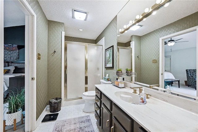 bathroom with connected bathroom, a textured ceiling, wallpapered walls, and a shower stall