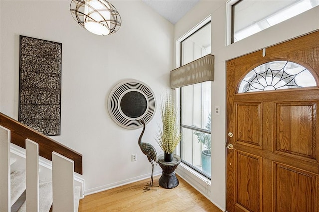 foyer featuring baseboards and light wood-style floors