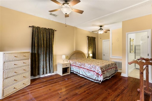 bedroom with wood finished floors, visible vents, and baseboards