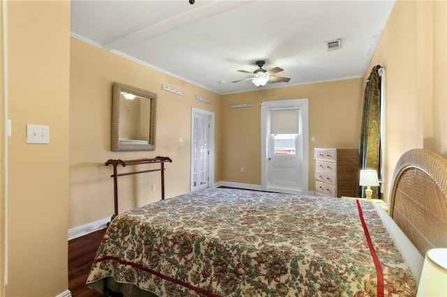 bedroom with baseboards, visible vents, dark wood-style flooring, and ornamental molding