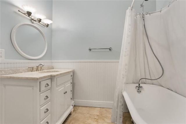 full bath with a wainscoted wall, a washtub, vanity, and a shower with shower curtain