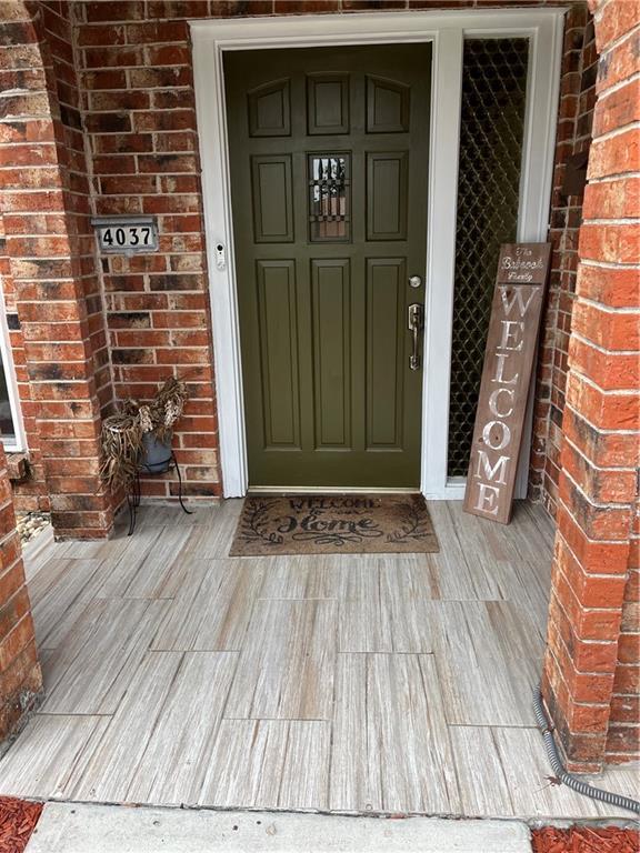 property entrance featuring brick siding