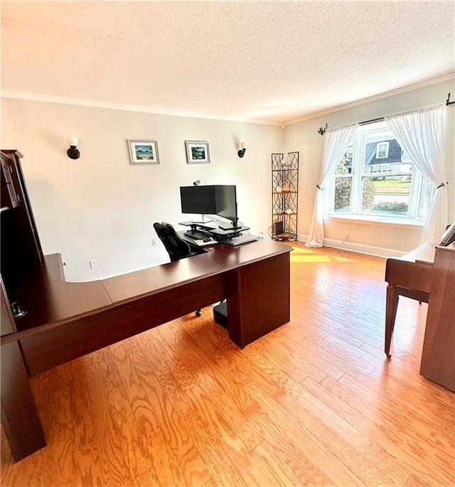 office space with crown molding, wood finished floors, baseboards, and a textured ceiling