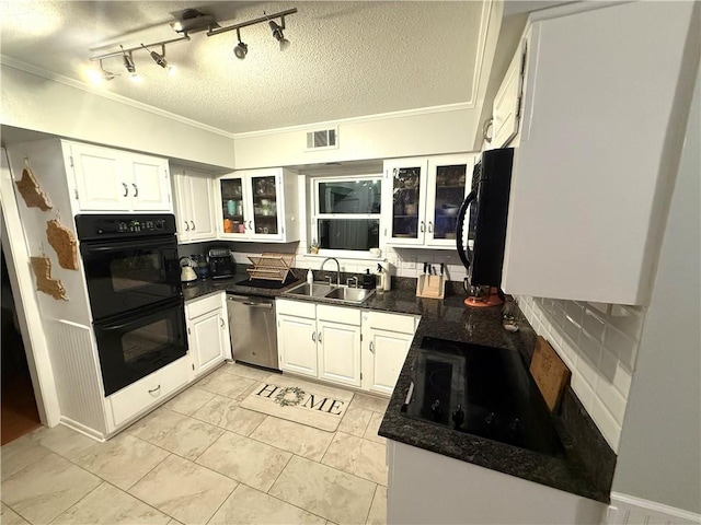 kitchen featuring a sink, dark countertops, black appliances, and ornamental molding