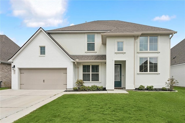 view of front facade with a shingled roof, a front yard, concrete driveway, and stucco siding