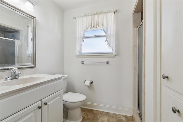 full bath featuring a shower stall, toilet, vanity, and baseboards