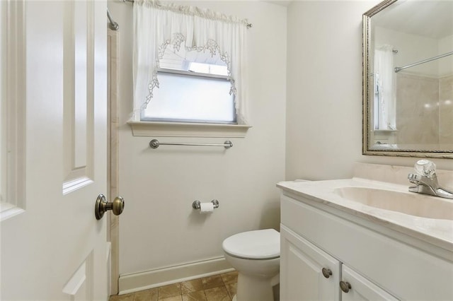 full bathroom featuring baseboards, toilet, walk in shower, and vanity