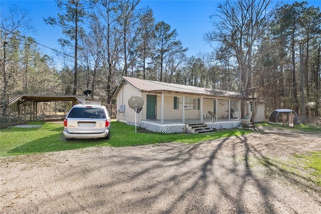 view of front of home with a porch, metal roof, and a front lawn