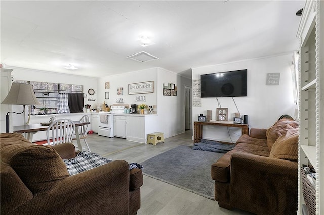 living area with light wood-type flooring and attic access