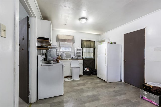 kitchen featuring light wood-type flooring, white appliances, washer / dryer, and white cabinetry