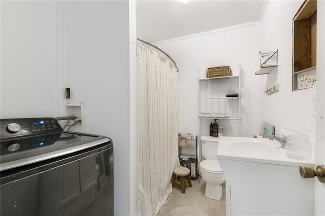 bathroom featuring toilet, curtained shower, washer / clothes dryer, and vanity