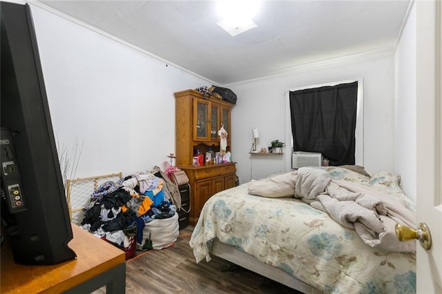 bedroom with dark wood finished floors and ornamental molding