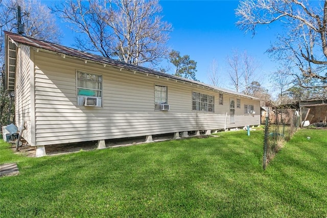 rear view of property with a yard and cooling unit