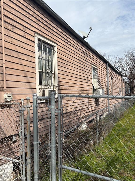 view of side of property featuring fence