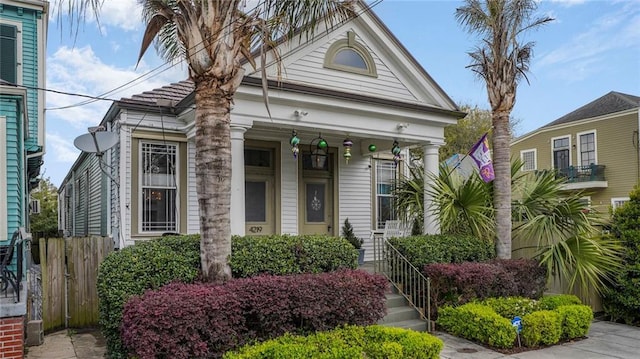 greek revival house featuring fence