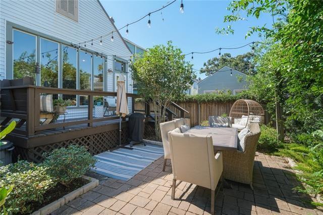 view of patio / terrace featuring a deck, outdoor dining area, and fence