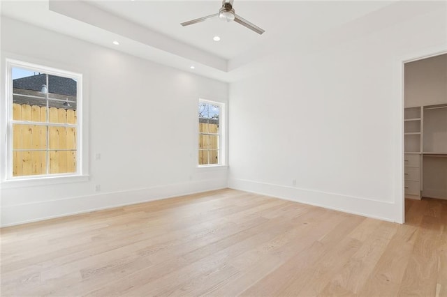 315 Sena Dr, Metairie, LA 70005 - unfurnished room featuring a raised ceiling, baseboards, light wood-style floors, ceiling fan, and recessed lighting