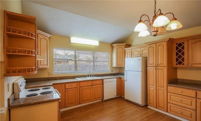 kitchen with white appliances, a sink, a textured ceiling, light wood-type flooring, and a chandelier