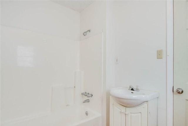 full bath featuring vanity and washtub / shower combination