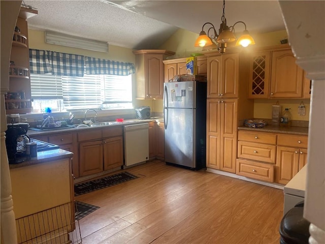 kitchen with light wood-style flooring, white dishwasher, freestanding refrigerator, a sink, and hanging light fixtures