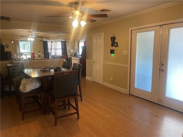 dining room featuring light wood-style flooring, french doors, and ceiling fan