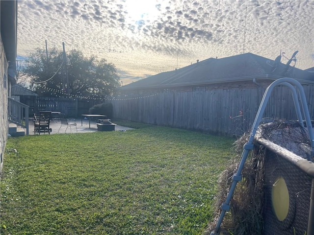 view of yard featuring a patio and a fenced backyard