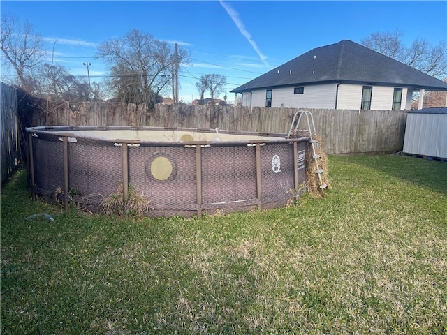 view of yard featuring a fenced in pool, an outdoor structure, and a fenced backyard