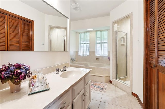 full bath with a closet, a garden tub, a shower stall, and tile patterned flooring