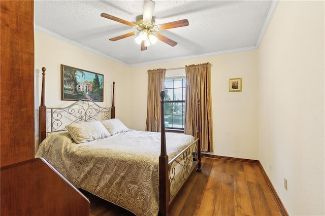 bedroom with wood finished floors, a textured ceiling, and ornamental molding