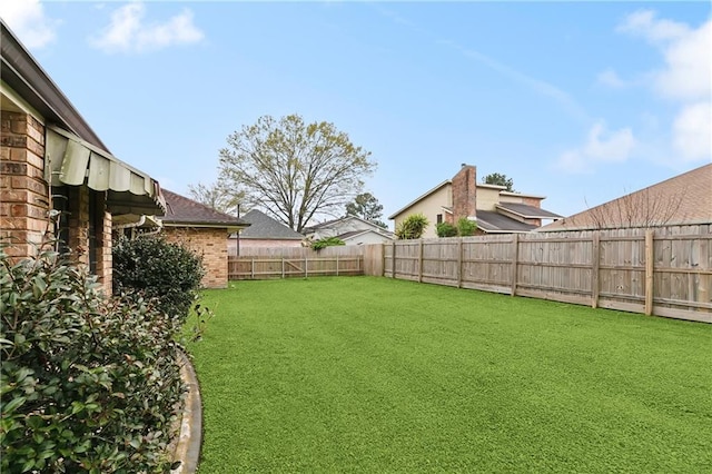 view of yard featuring a fenced backyard