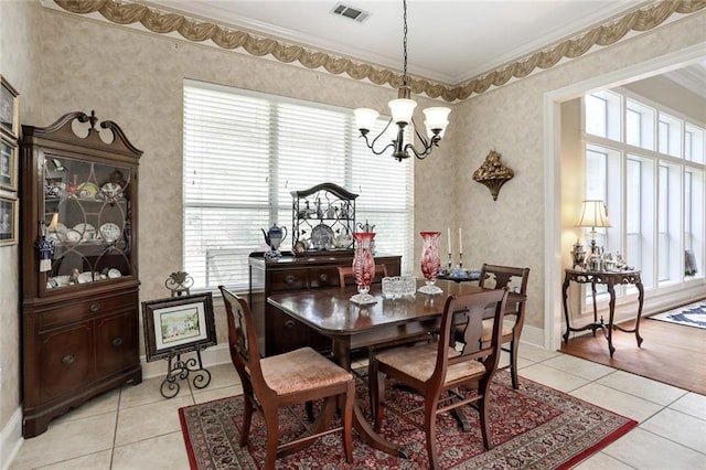 dining room with wallpapered walls, visible vents, light tile patterned floors, crown molding, and a notable chandelier