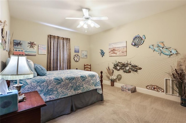 carpeted bedroom with a ceiling fan and baseboards