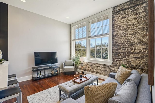 living area with recessed lighting, baseboards, and wood finished floors