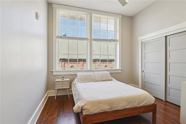 bedroom featuring dark wood-style floors and baseboards